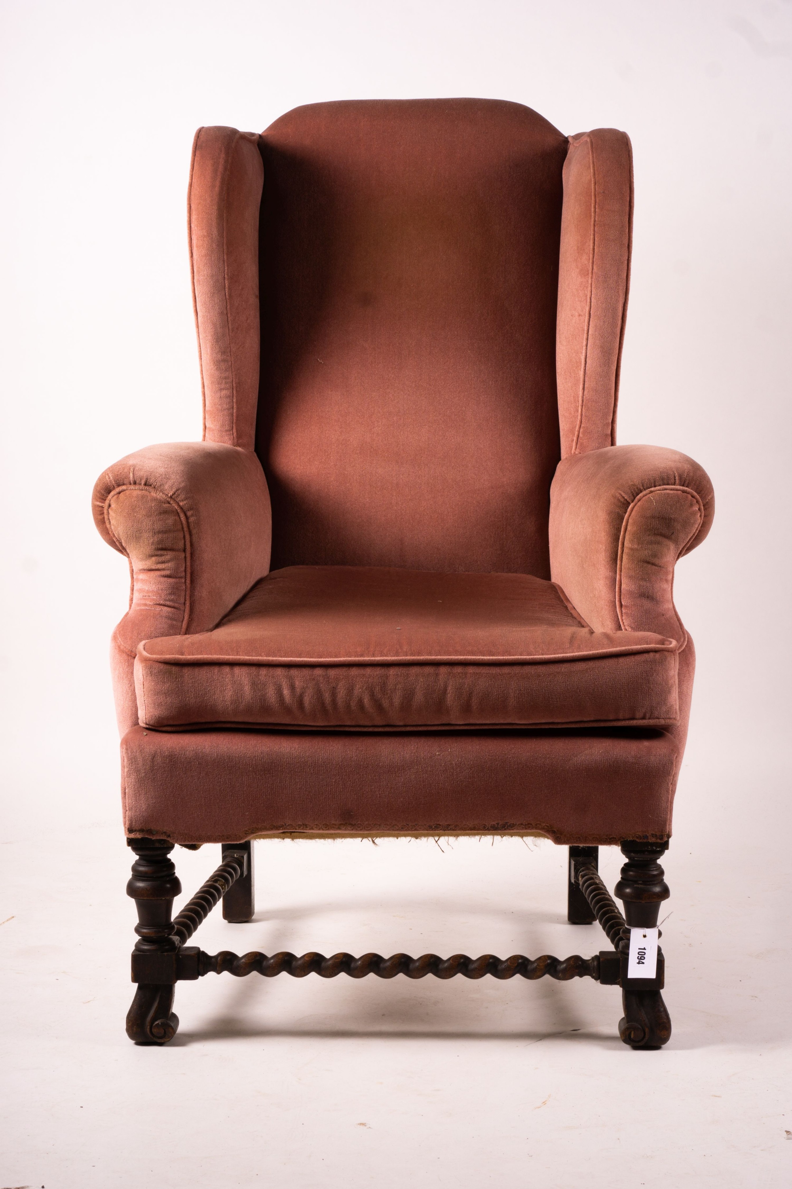 An early 20th century Jacobean revival upholstered wing armchair, width 84cm, depth 90cm, height 128cm